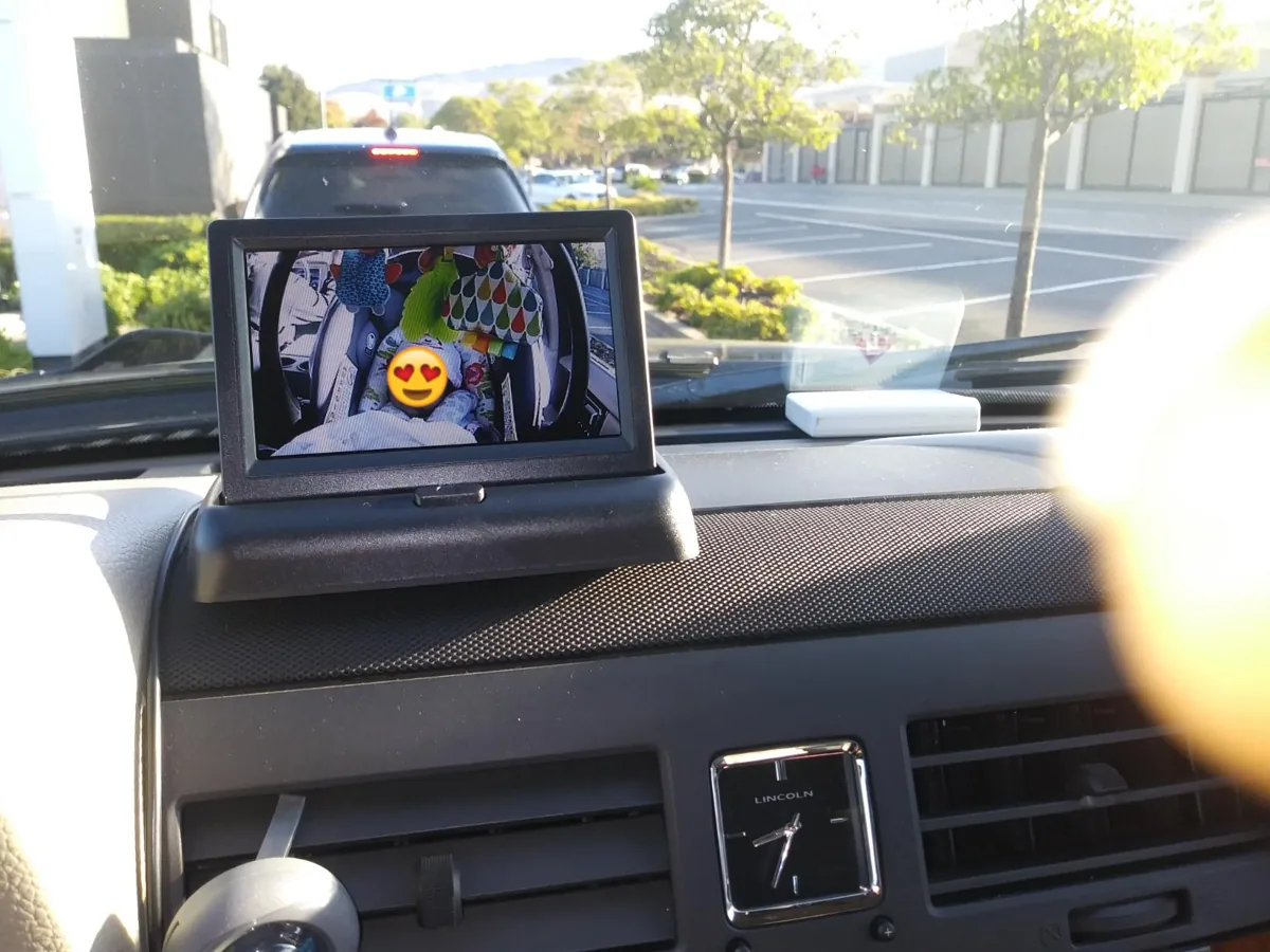 Small dashboard monitor showing a live view of the back seat