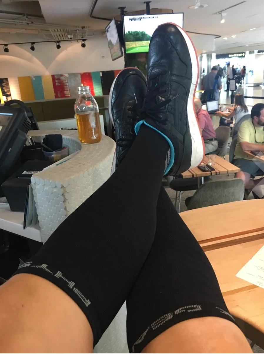 Black knee-high compression socks worn up to the calf