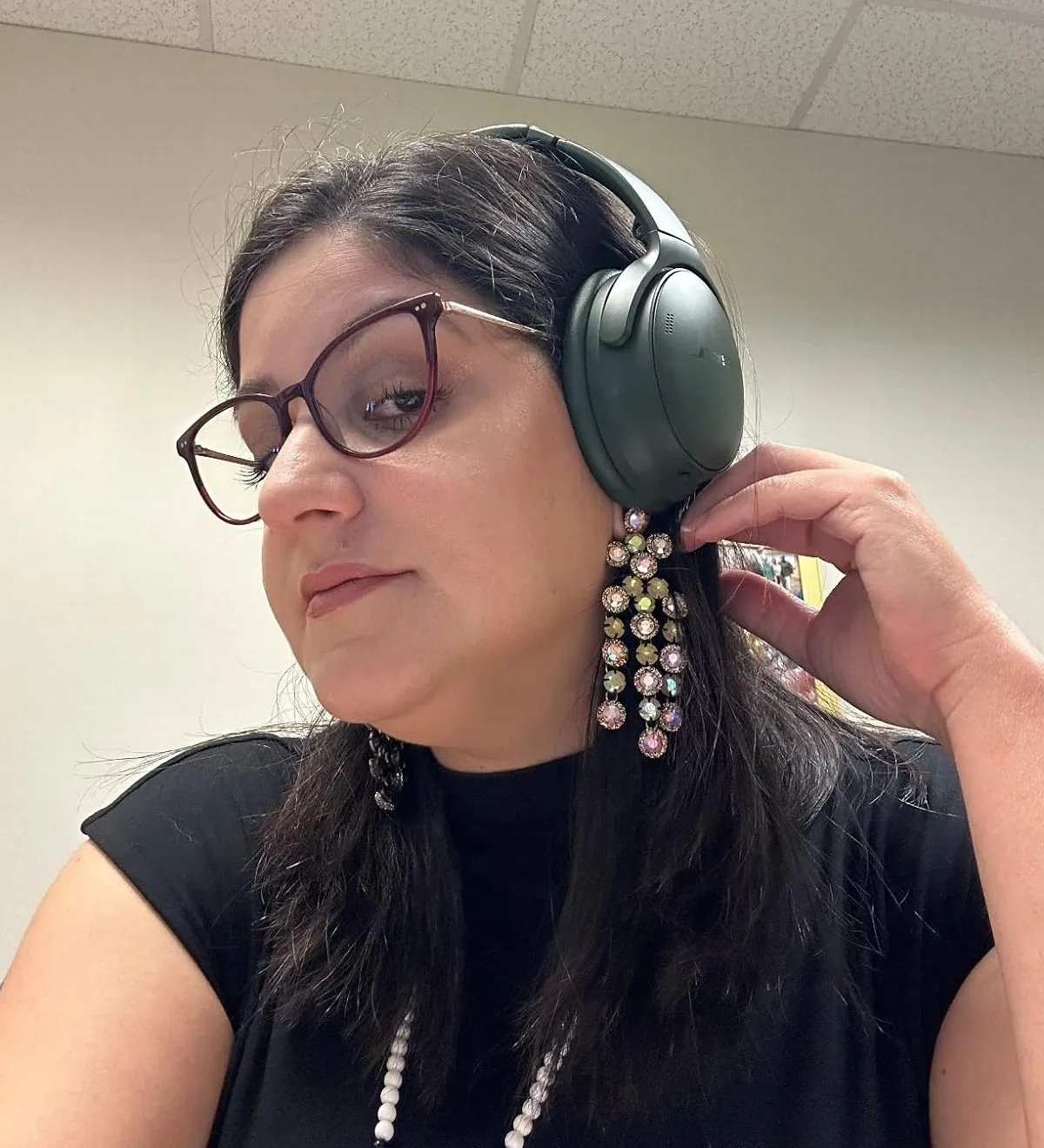 Green Bose QuietComfort over-ear headphones being worn
