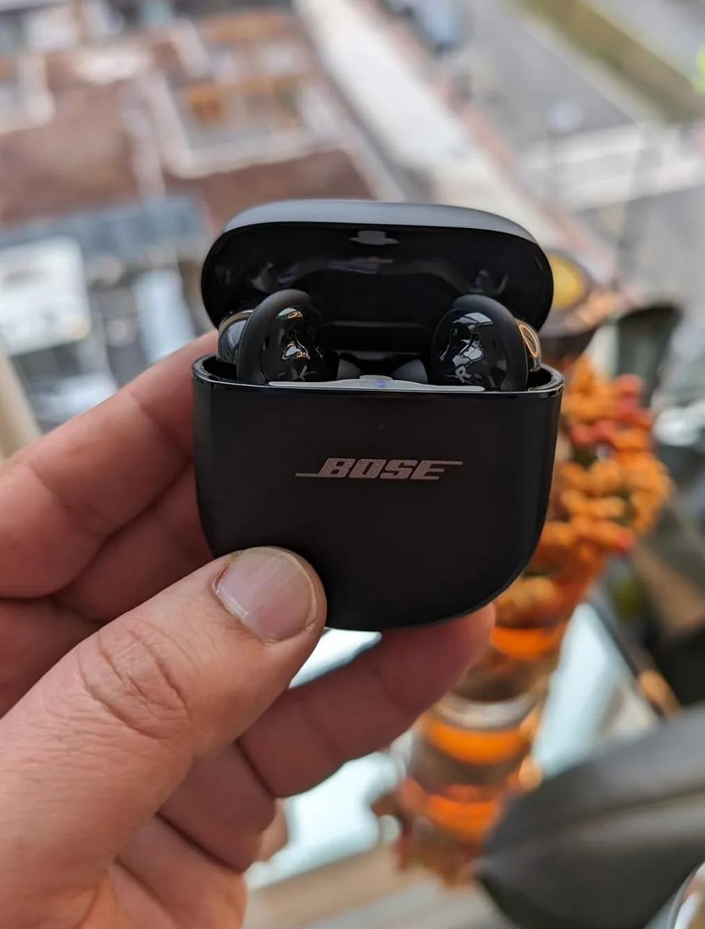 Bose QuietComfort Ultra earbuds in their open charging case