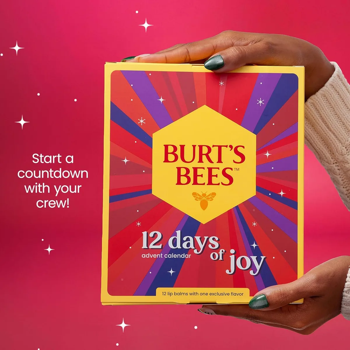Hands holding a Burt's Bees Days of Joy advent calendar filled with lip balms