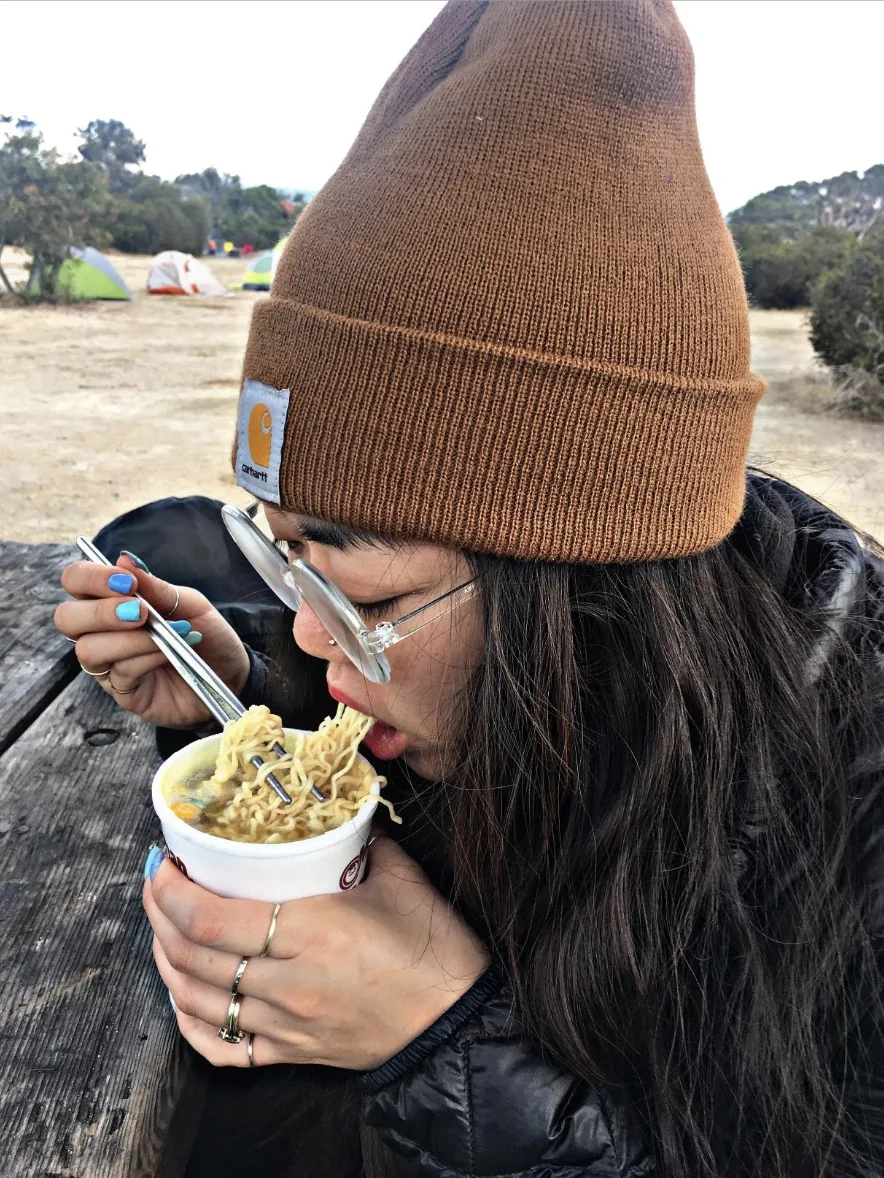 Person wearing a brown Carhartt knit cuffed beanie outdoors