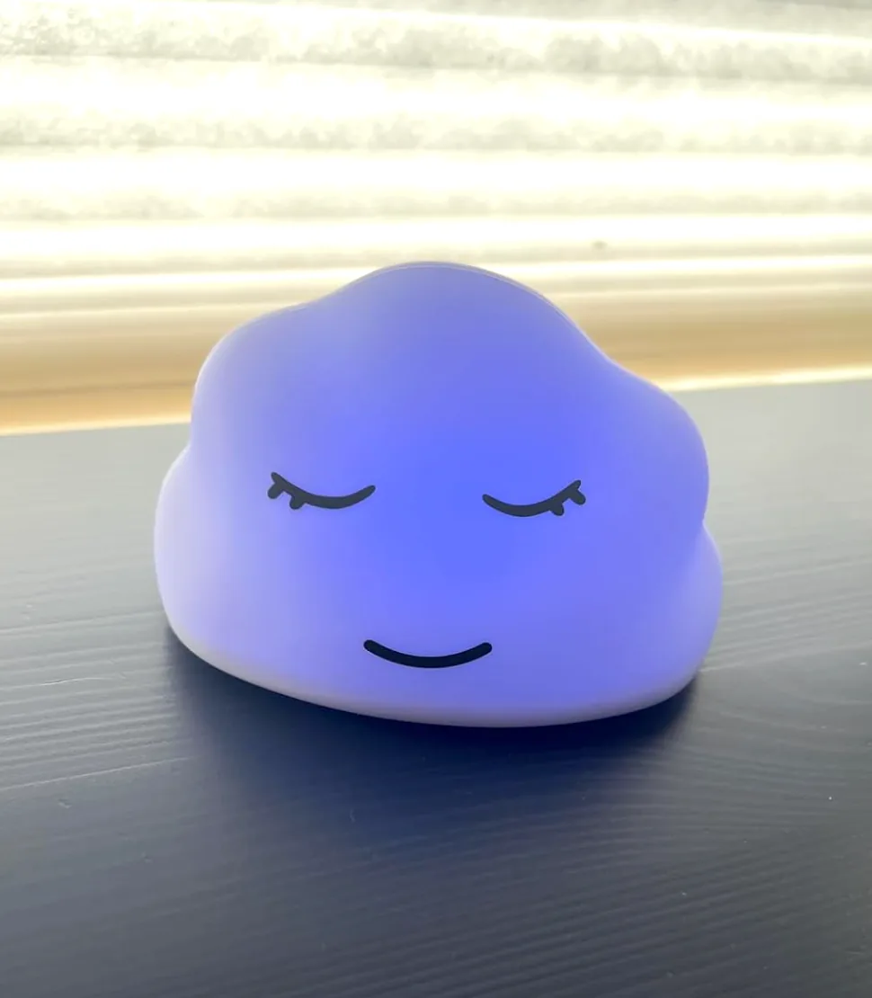 Squishy cloud breathing lamp glowing softly on a table