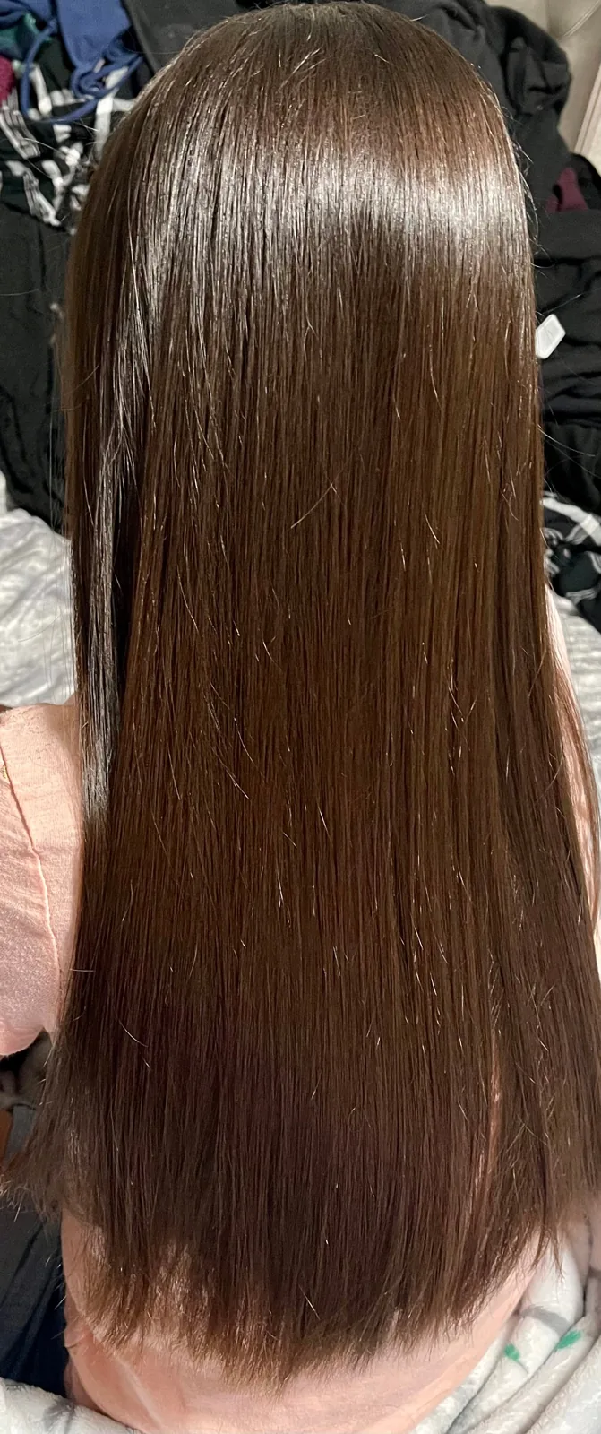 Long sleek brown hair styled with Color Wow anti-frizz spray