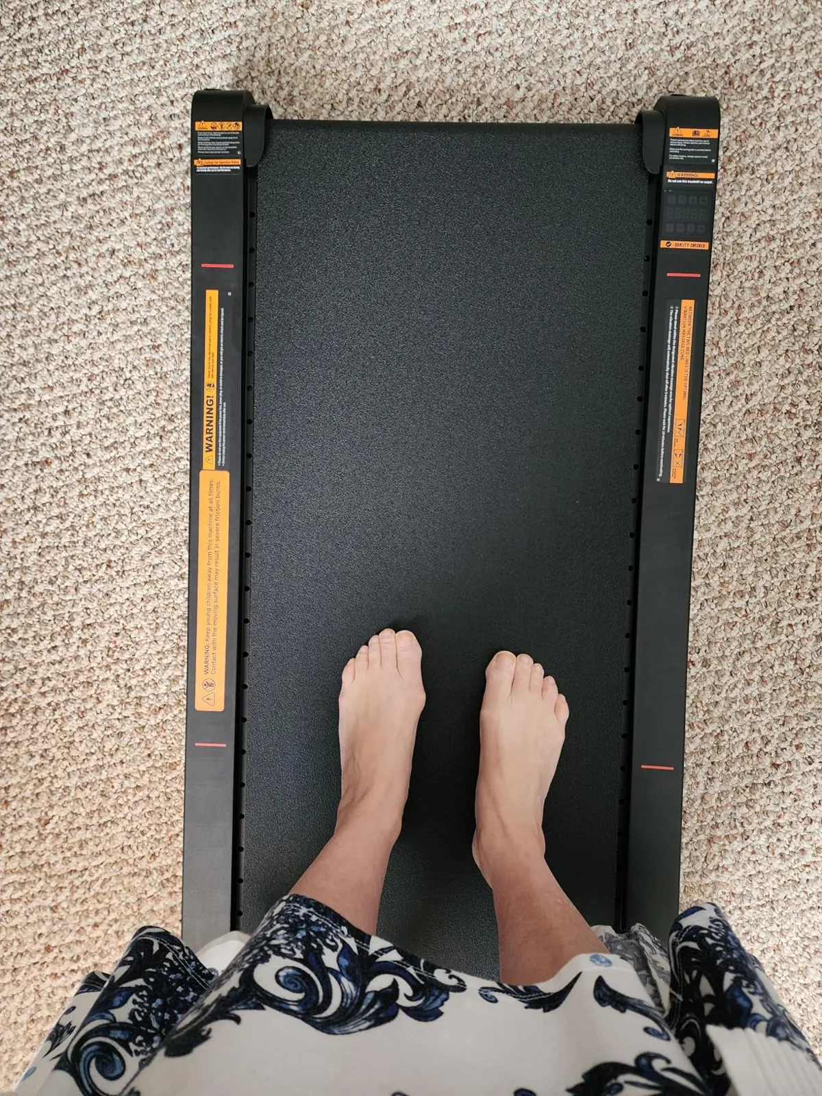 Compact walking pad with remote set up in a living room
