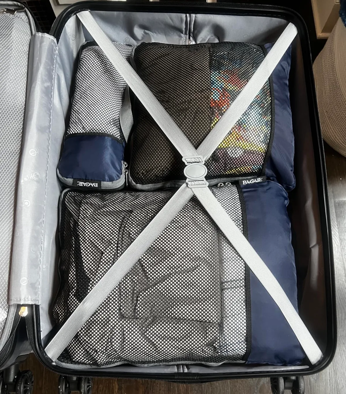 Navy compression packing cubes packed neatly inside an open suitcase