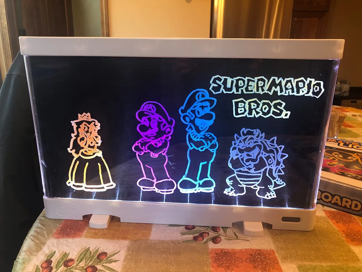Crayola light board glowing with a colorful traced drawing