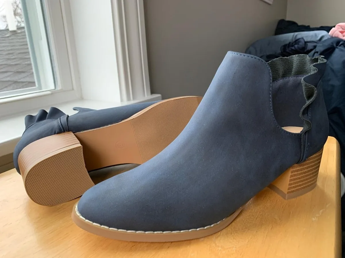 Navy suede-look ankle booties with side cutouts, ruffle trim and stacked wooden heels