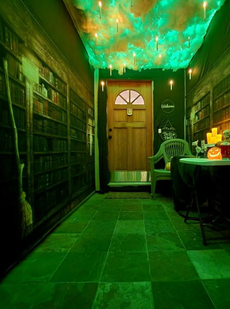 Flameless floating candles hanging from the ceiling of a decorated hallway