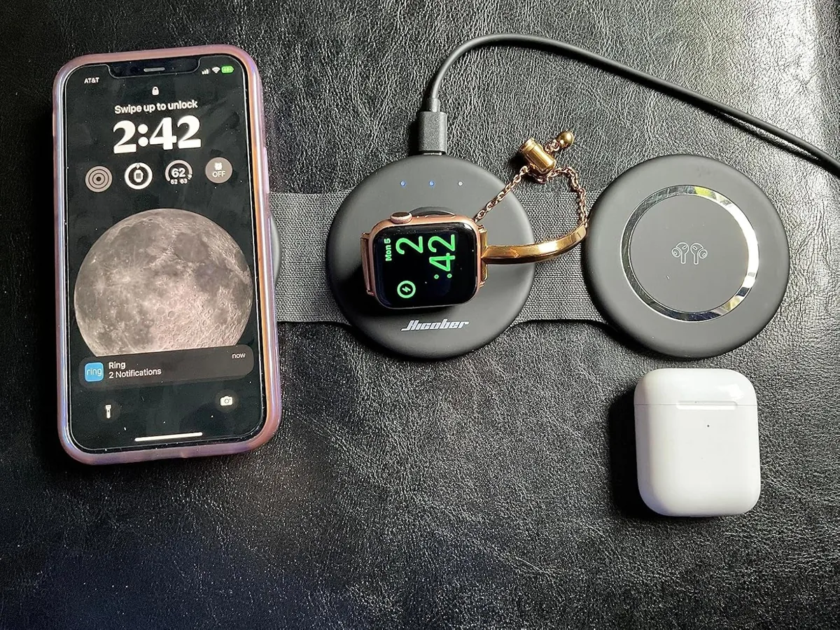 Foldable wireless charger pads laid flat with a phone, smartwatch and earbuds case