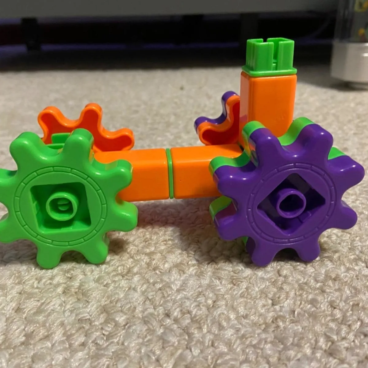 Green, orange and purple pieces connected from a Gears building set