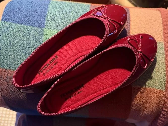 Pair of glossy ballet flats with small bow accents