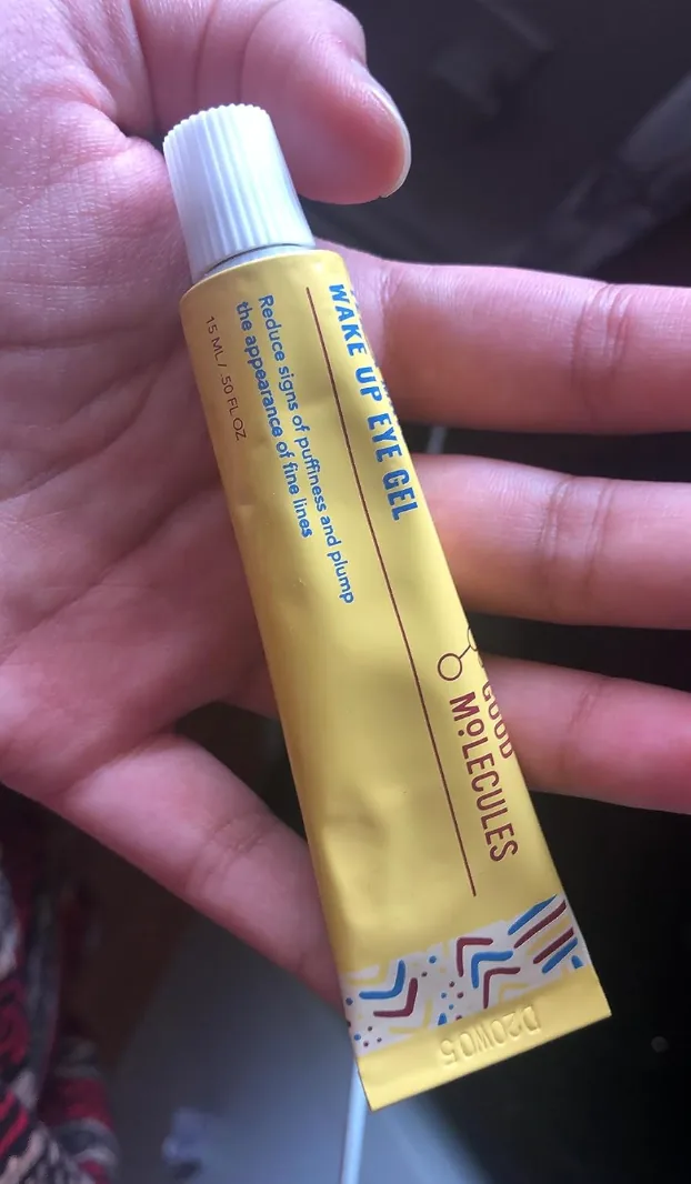 Hand holding a tube of Good Molecules Yerba Mate Wake Up Eye Gel