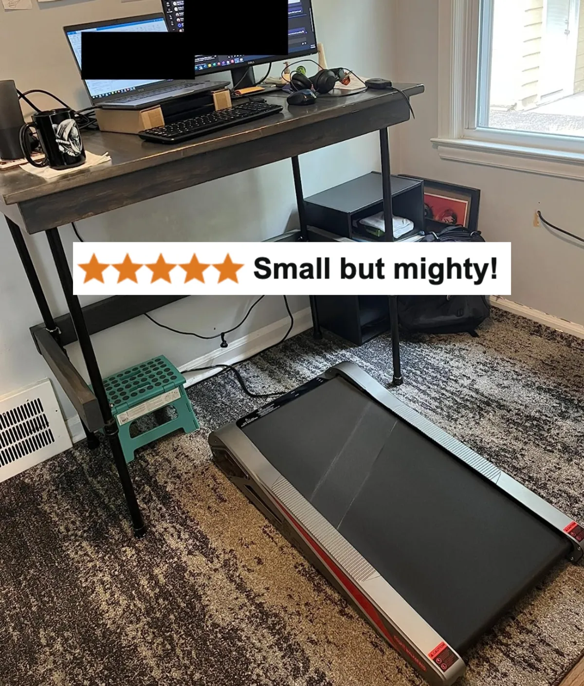 Small incline treadmill under a standing desk in a home office