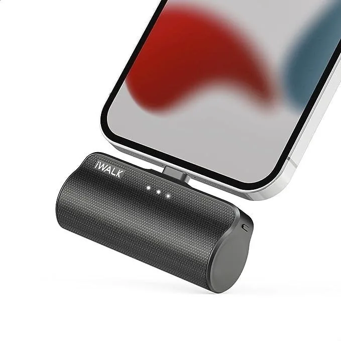 Small iWalk portable charger plugged into the bottom of a phone