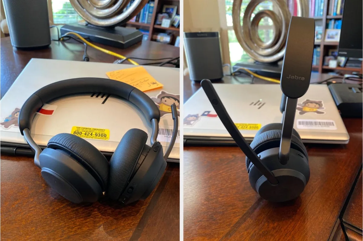 Jabra Evolve wireless headset shown flat and upright with its mic arm raised on a desk