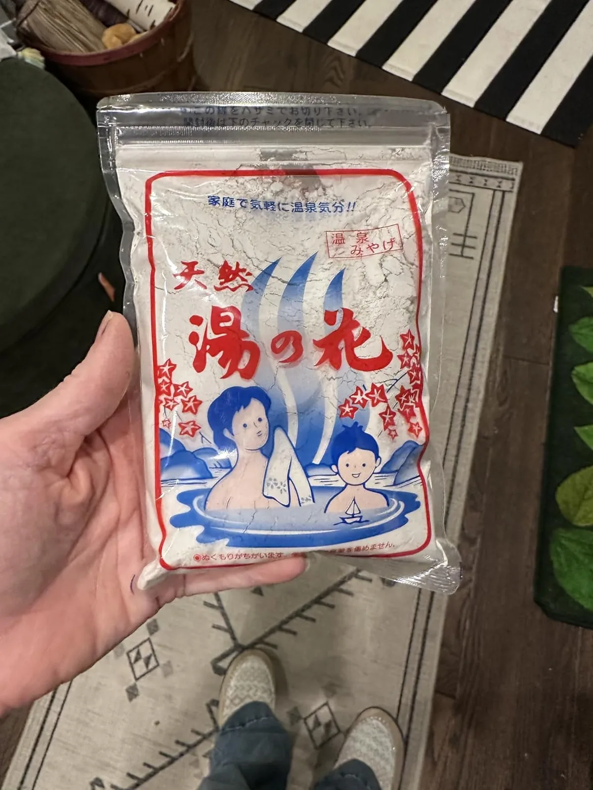 Hand holding a pouch of Japanese hot spring bath powder