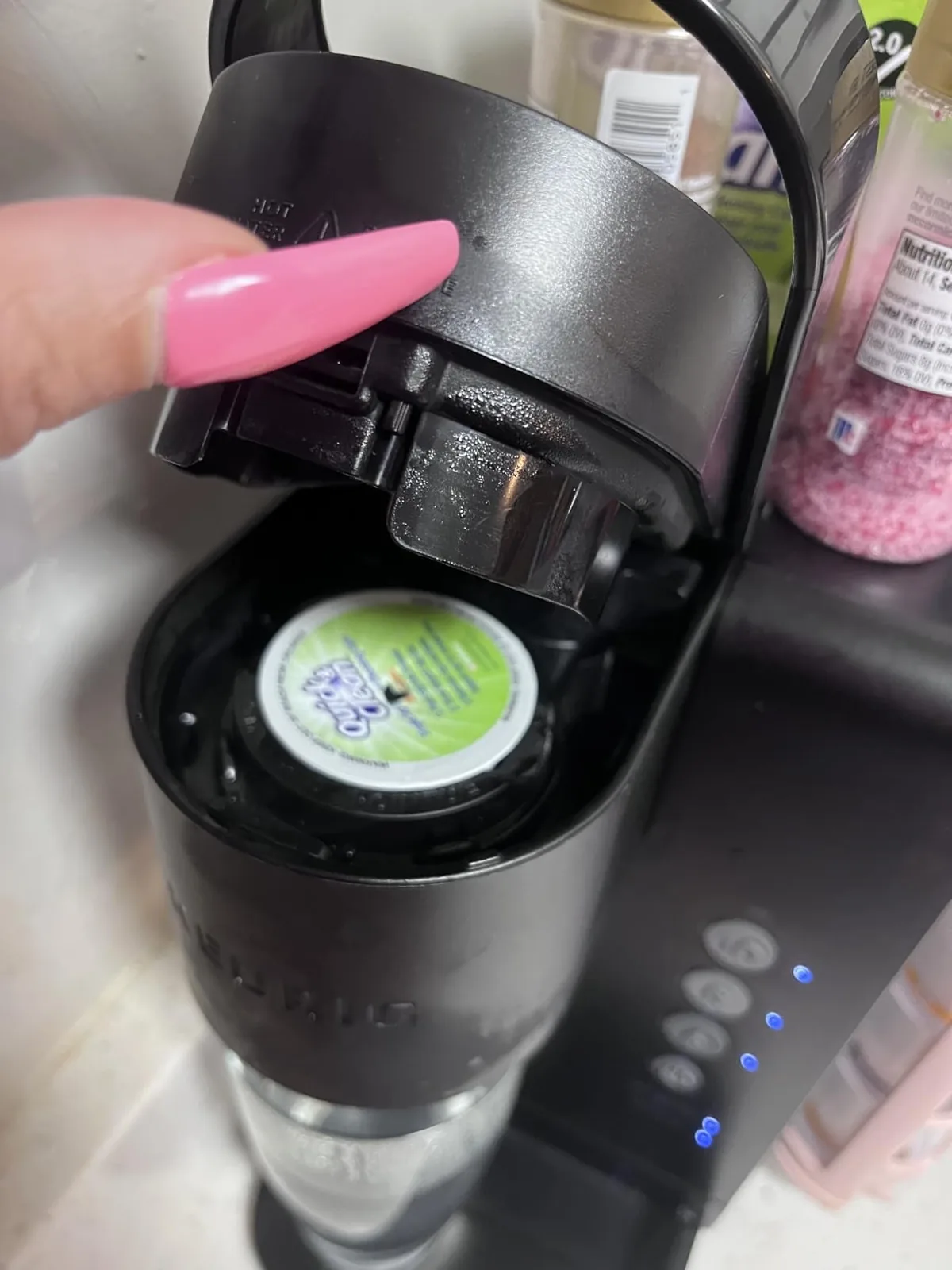 Cleaning pod loaded into a single-serve coffee maker