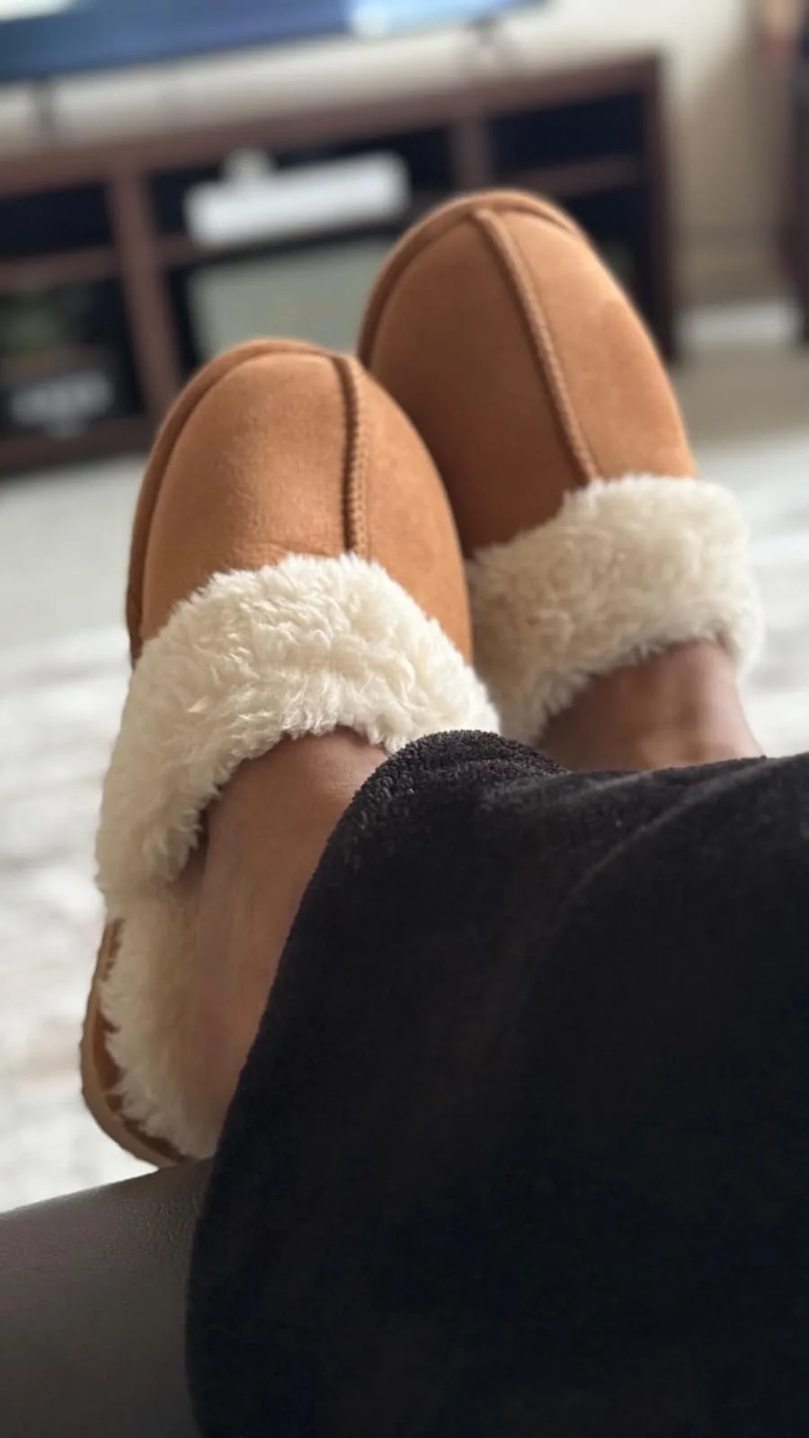 Feet propped up in chestnut Litfun fuzzy memory foam slippers
