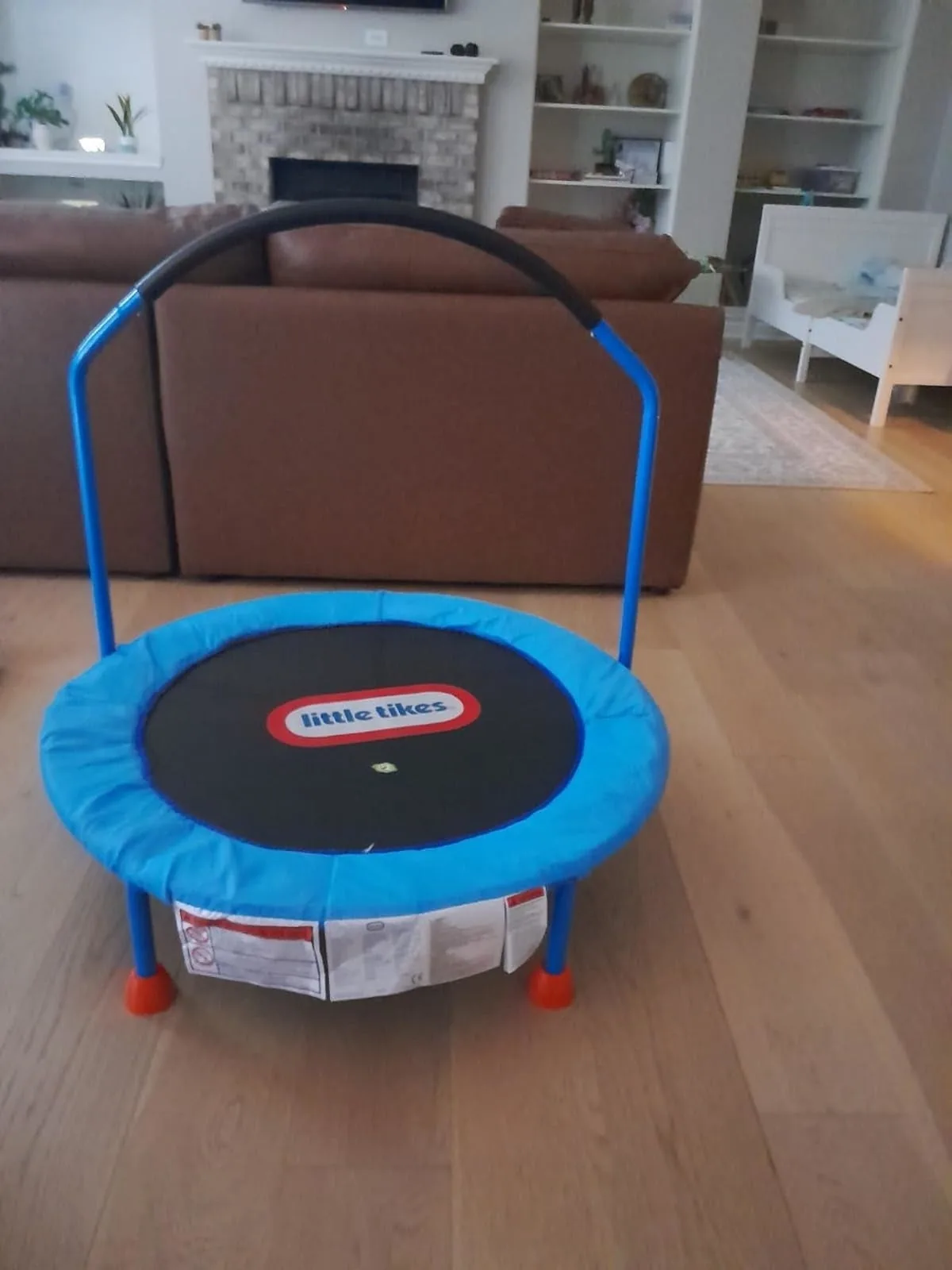 Little Tikes toddler trampoline with a handlebar in a living room