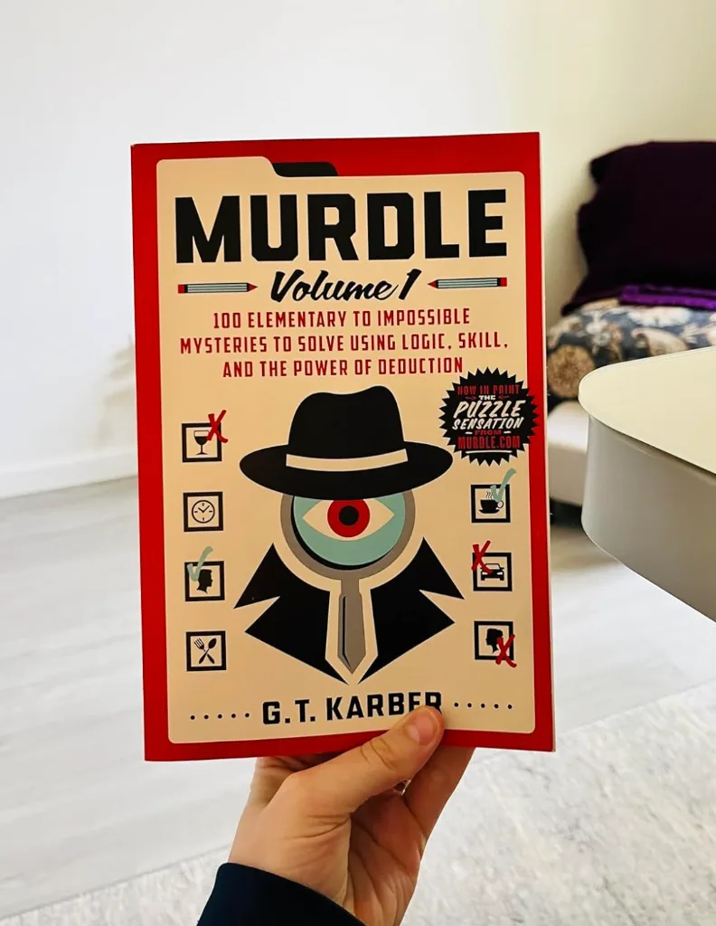 Hand holding the Murdle murder mystery logic puzzle book
