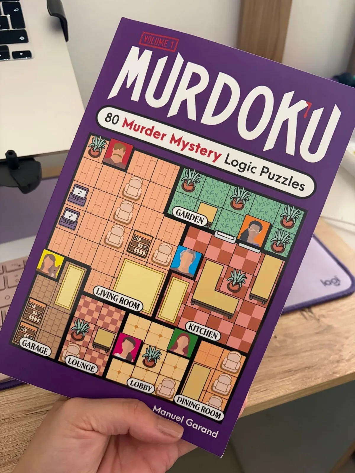 Hand holding the Murdoku murder mystery logic puzzle book