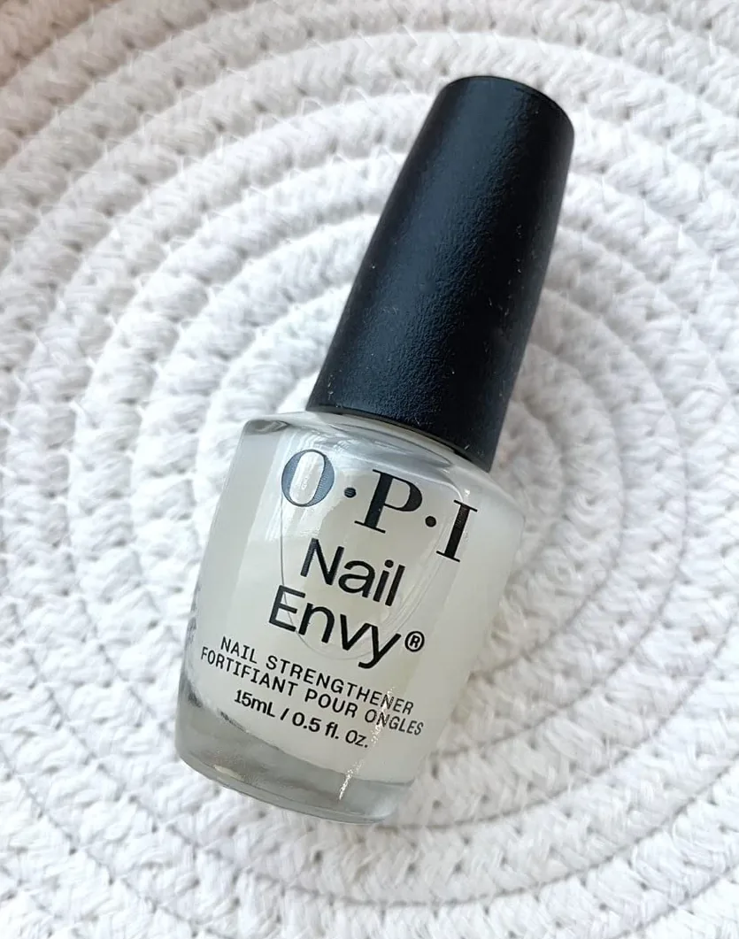 Bottle of OPI Nail Envy nail strengthener on a textured surface
