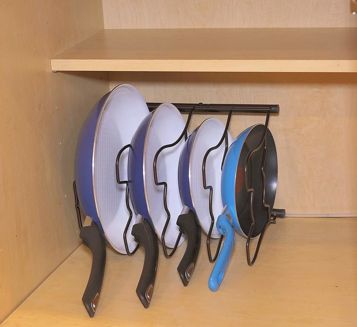 Pan organizer rack laid on its side with frying pans standing upright in the slots