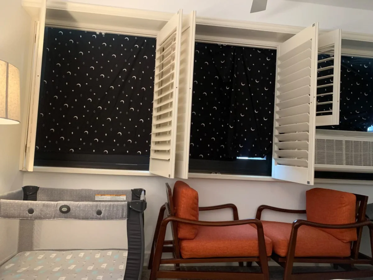 Portable moon and stars blackout shades covering windows in a guest room