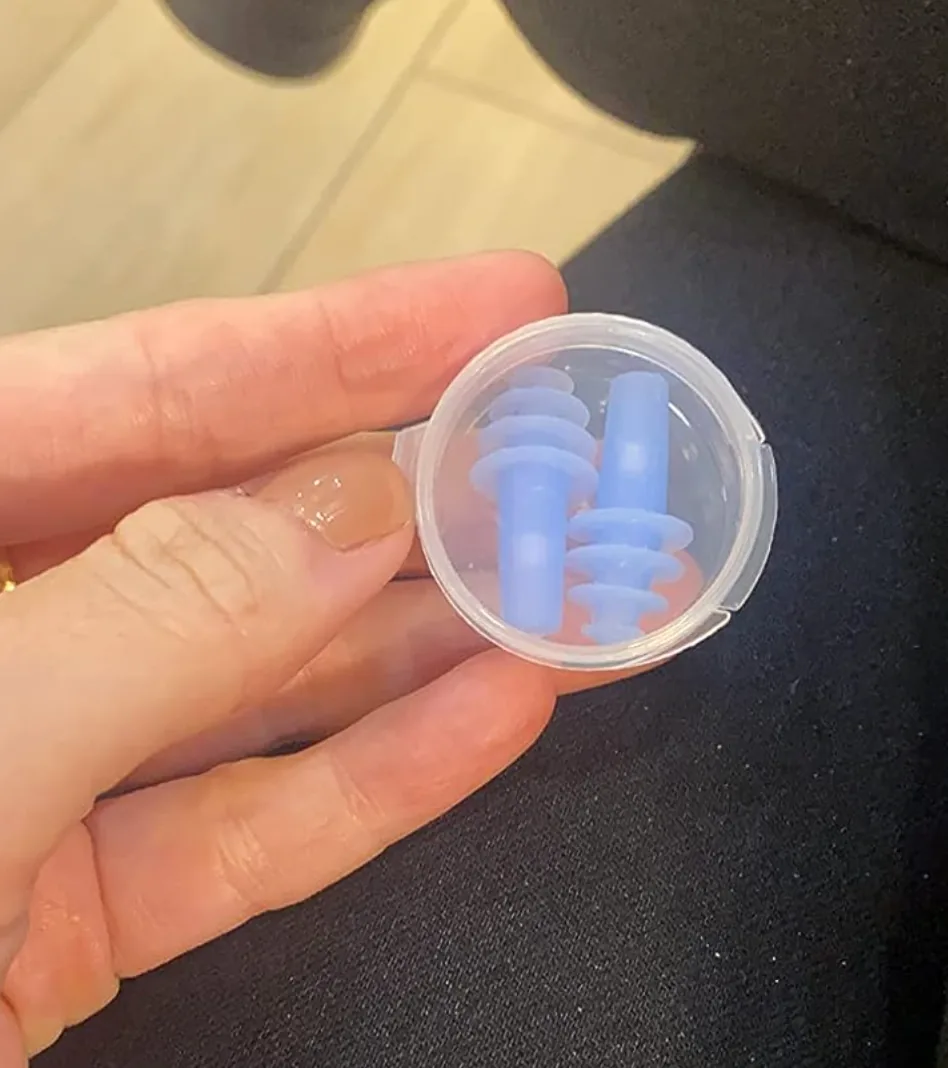 Small blue spiral pressure-relief earplugs in their carry case