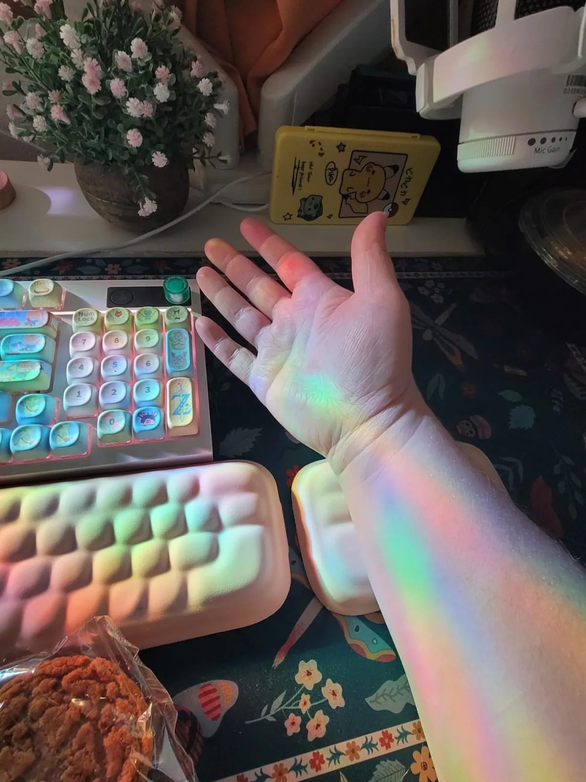 Rainbow light from an iridescent window privacy film falling across a desk
