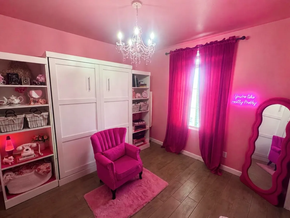 Hot pink velvet curtains hanging in a pink bedroom