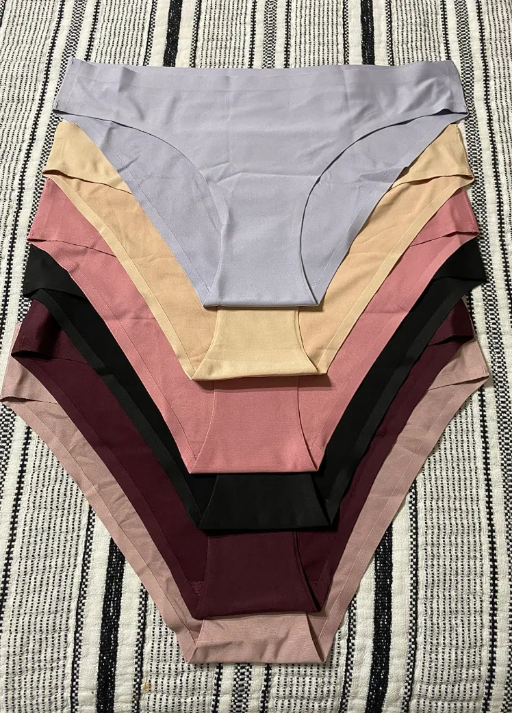 Stack of seamless no-show underwear in lavender, tan, rose, black and burgundy