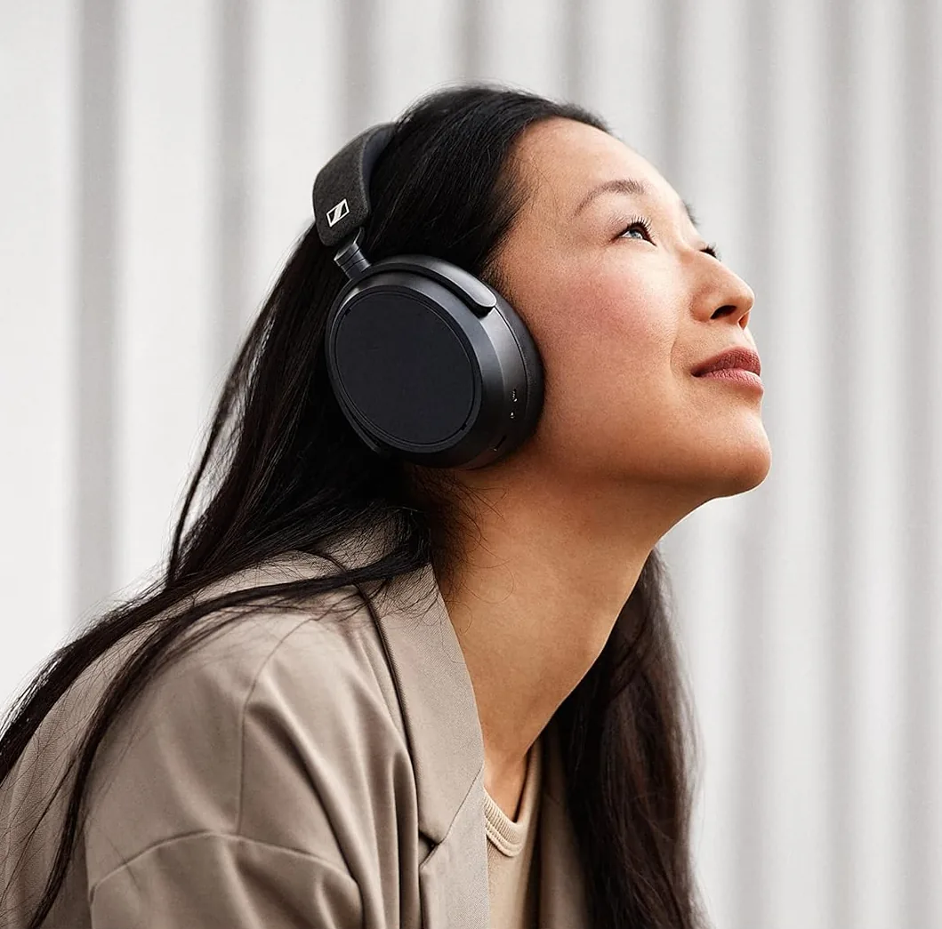 Woman wearing black Sennheiser Momentum wireless over-ear headphones