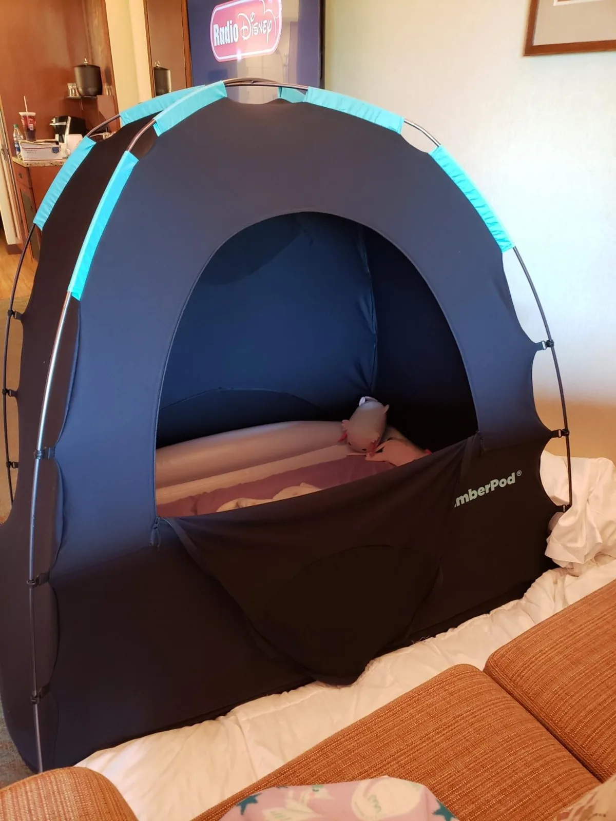 SlumberPod blackout privacy pod set up over a travel crib