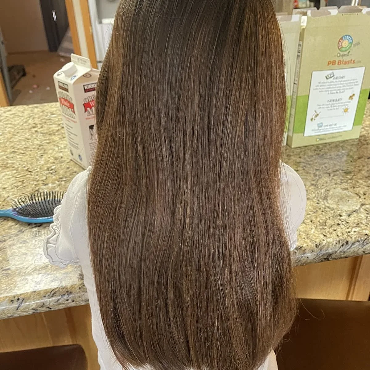 Long smooth brown hair after brushing with a detangling brush