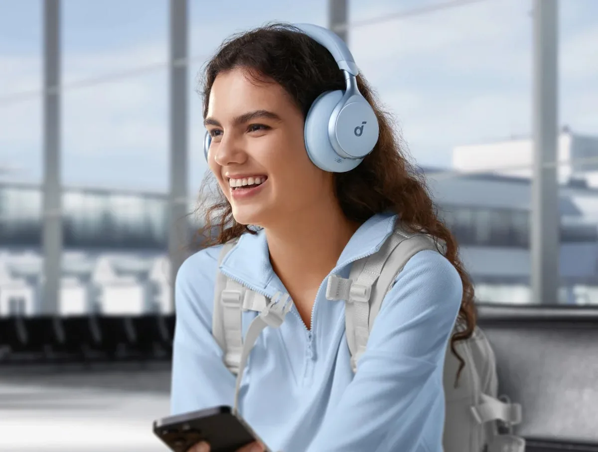 Light blue Soundcore Space One headphones on a smiling commuter