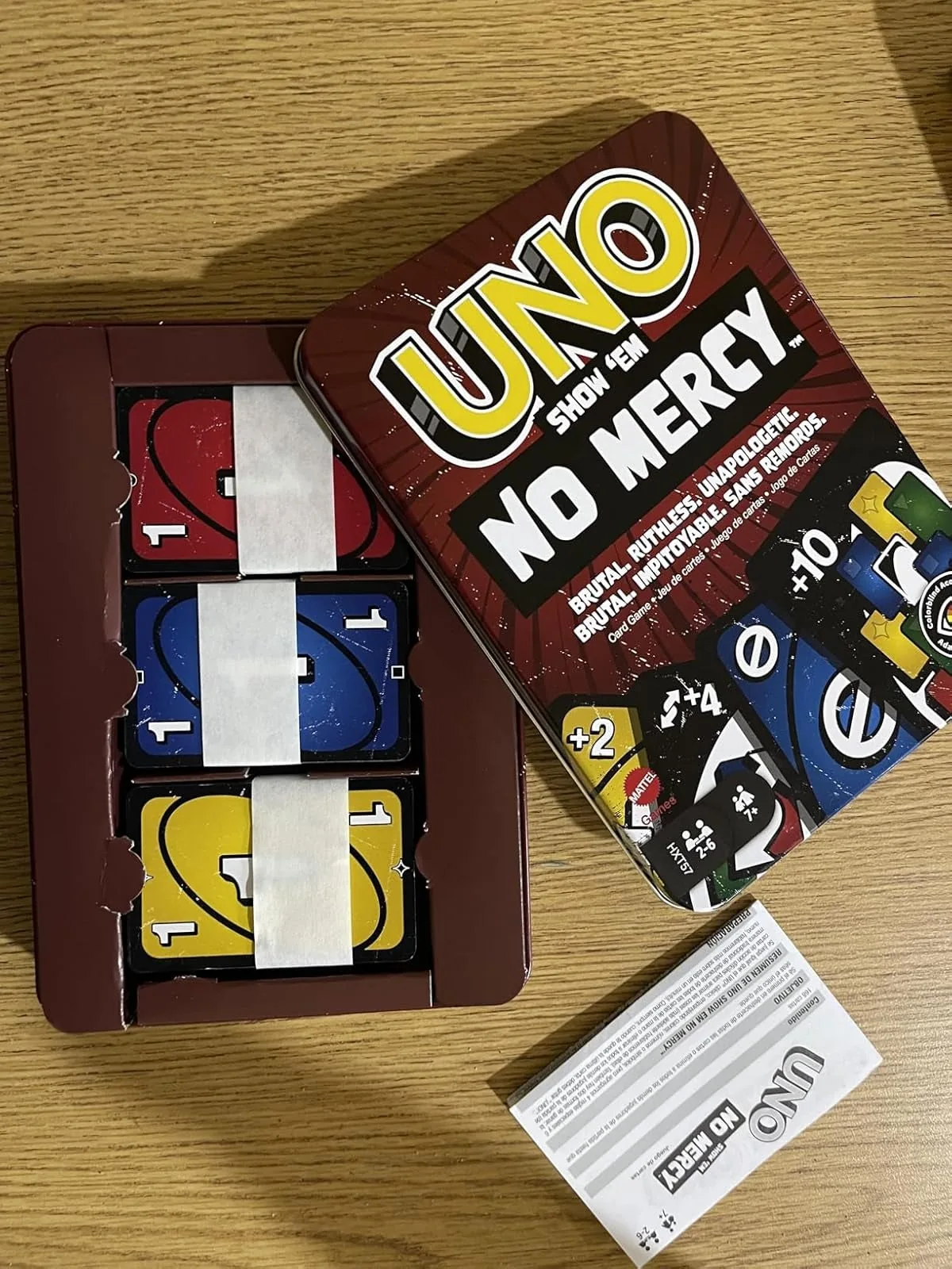 Uno Show Em No Mercy cards inside their open tin