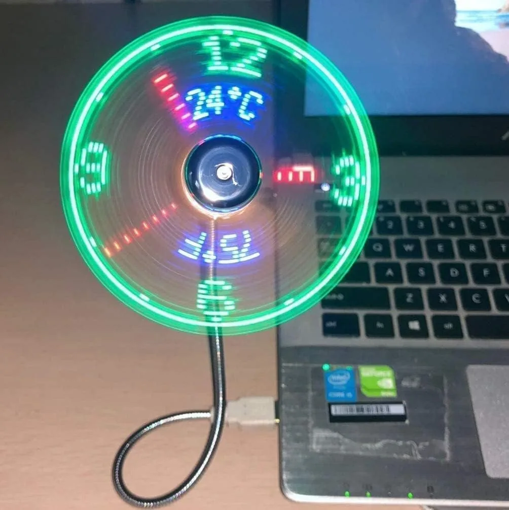 USB fan with a glowing LED clock and temperature display plugged into a laptop
