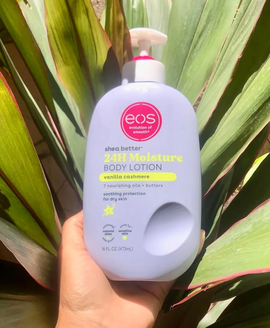 Hand holding a bottle of vanilla cashmere body lotion