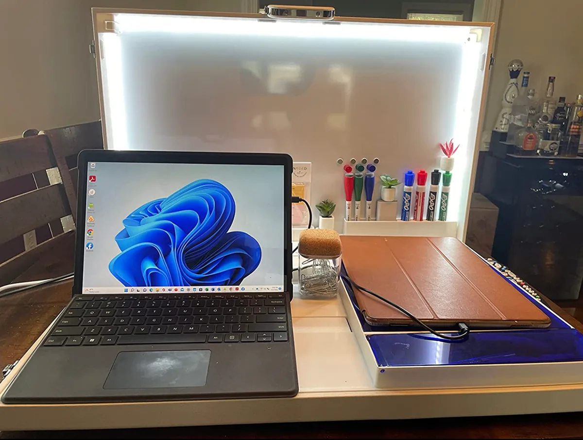 Open Worky desk station with a laptop, LED-lit whiteboard and supply compartments