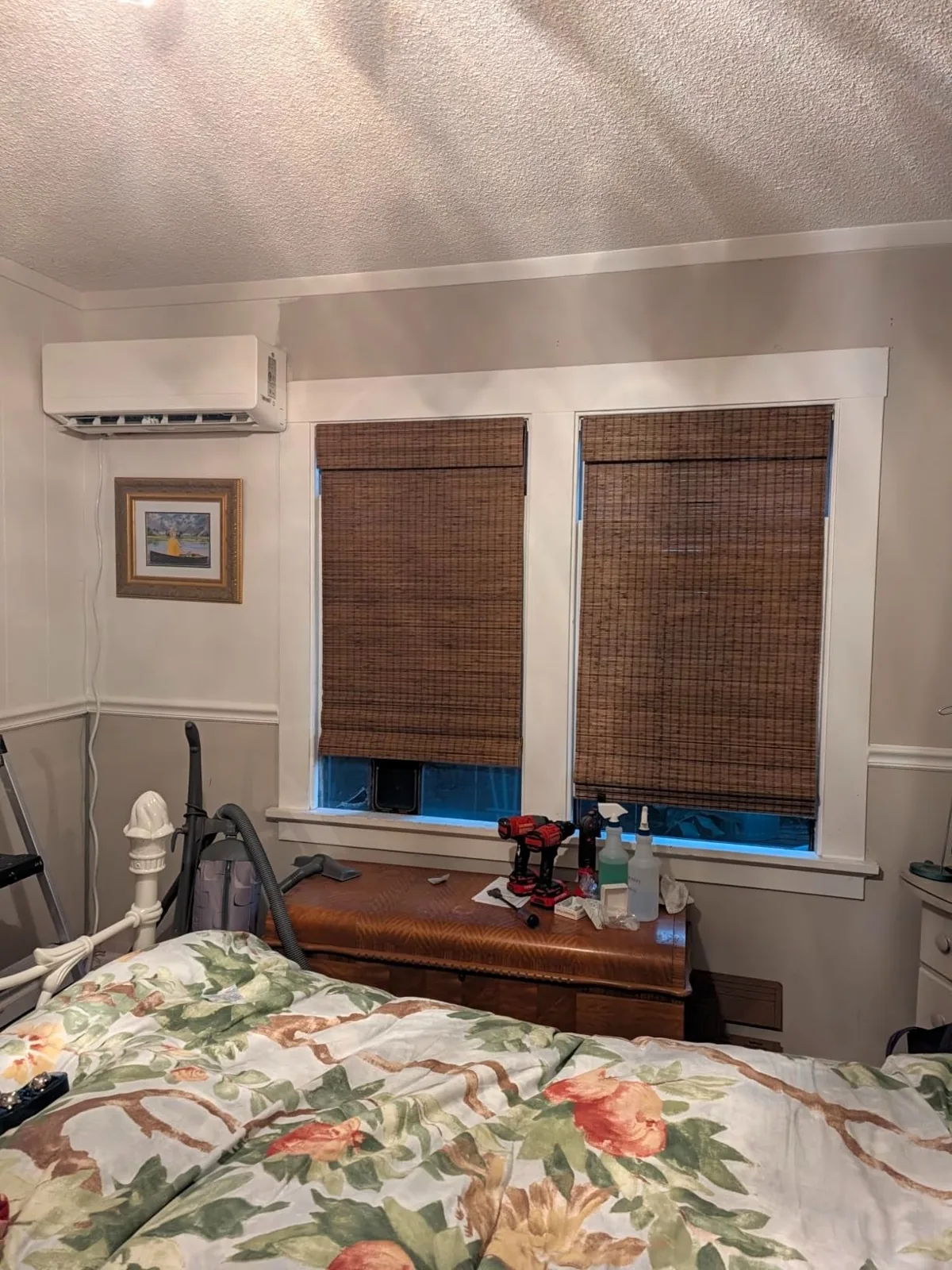 Woven bamboo Roman shades lowered on two bedroom windows